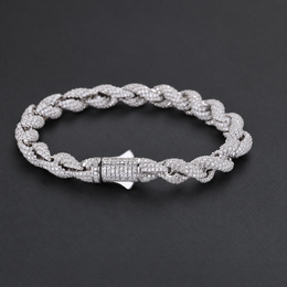 Rope bracelet on a dark surface, showing the front of its box clasp