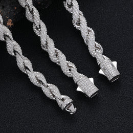 Rope links and open box clasp connections with side safety catches on a dark surface