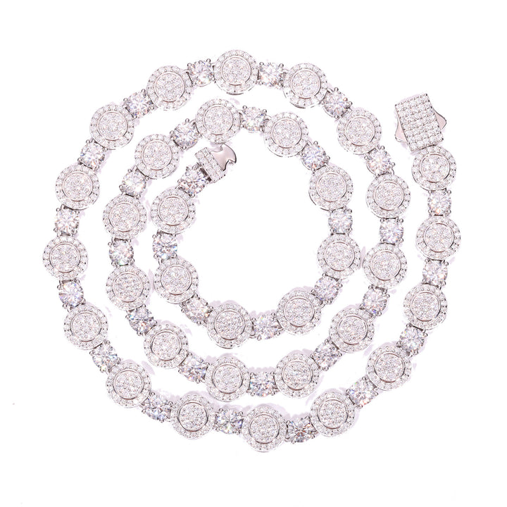 Silver-tone moissanite halo tennis chain coiled on white with its stone-set clasp visible