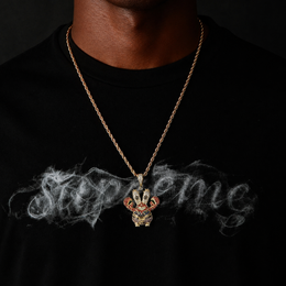 Gold iced cartoon crab character pendant worn by a deep-brown model