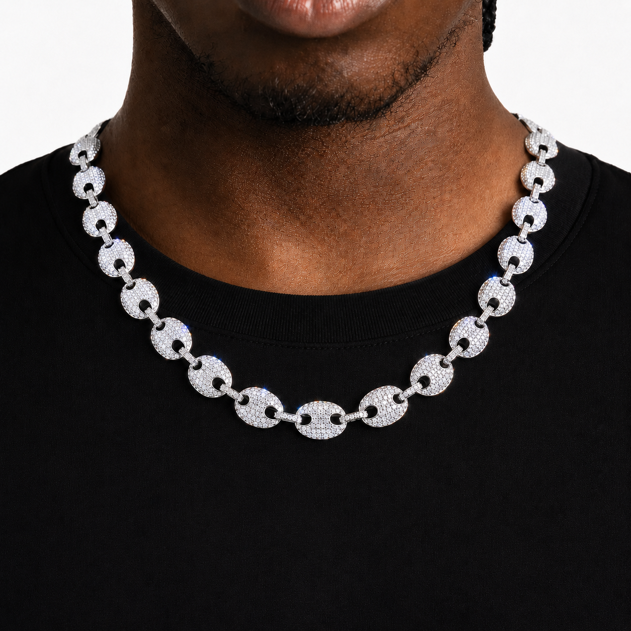 Silver-tone stone-set oval-link necklace worn over a black shirt