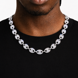Silver-tone stone-set oval-link necklace worn over a black shirt