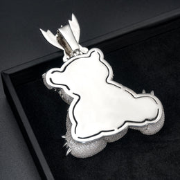 Polished back of the bear pendant showing its outline and the rear of the bail