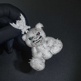 Gloved hand holding the pavé bear pendant by its ornate bail
