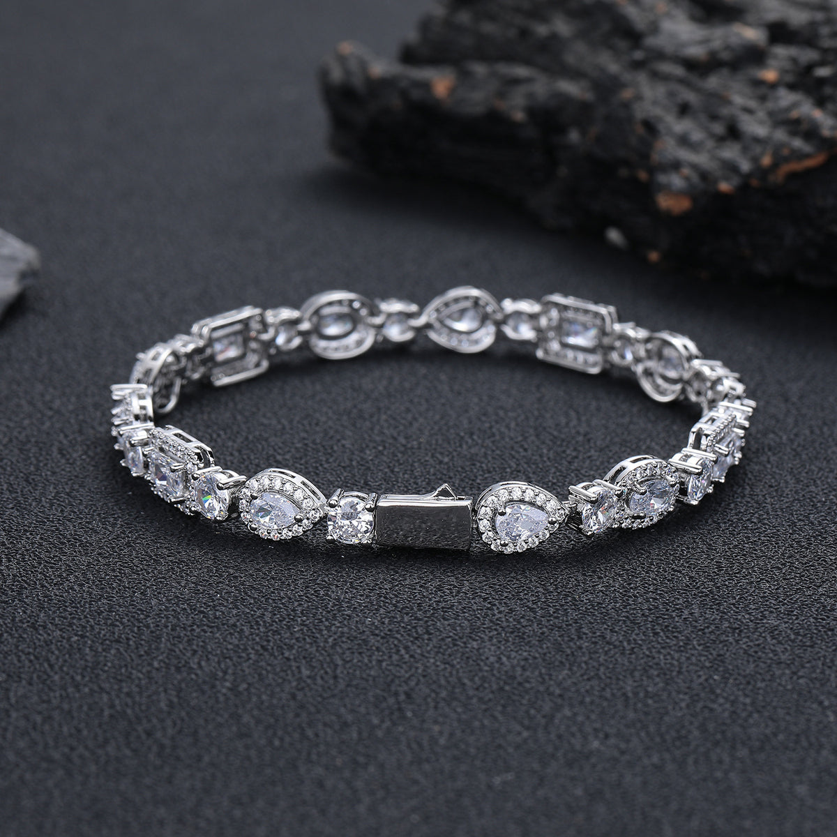 Silver-tone geometric bracelet showing the box clasp on dark stone