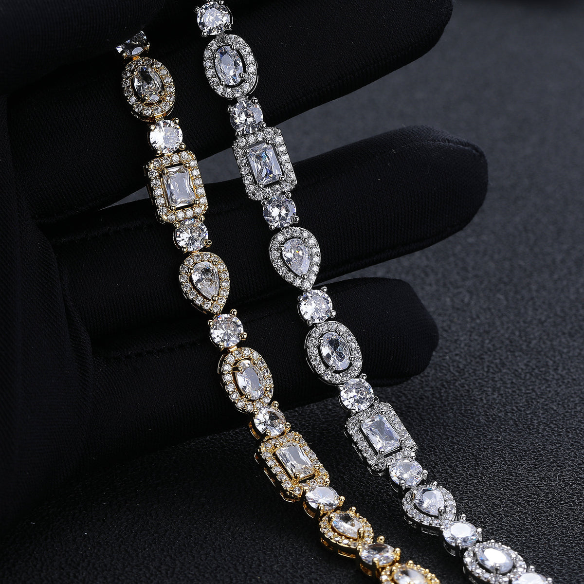 Close-up of silver-tone and gold-tone halo links held in a black glove