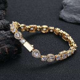 Gold-tone geometric bracelet showing the box clasp and back of the links