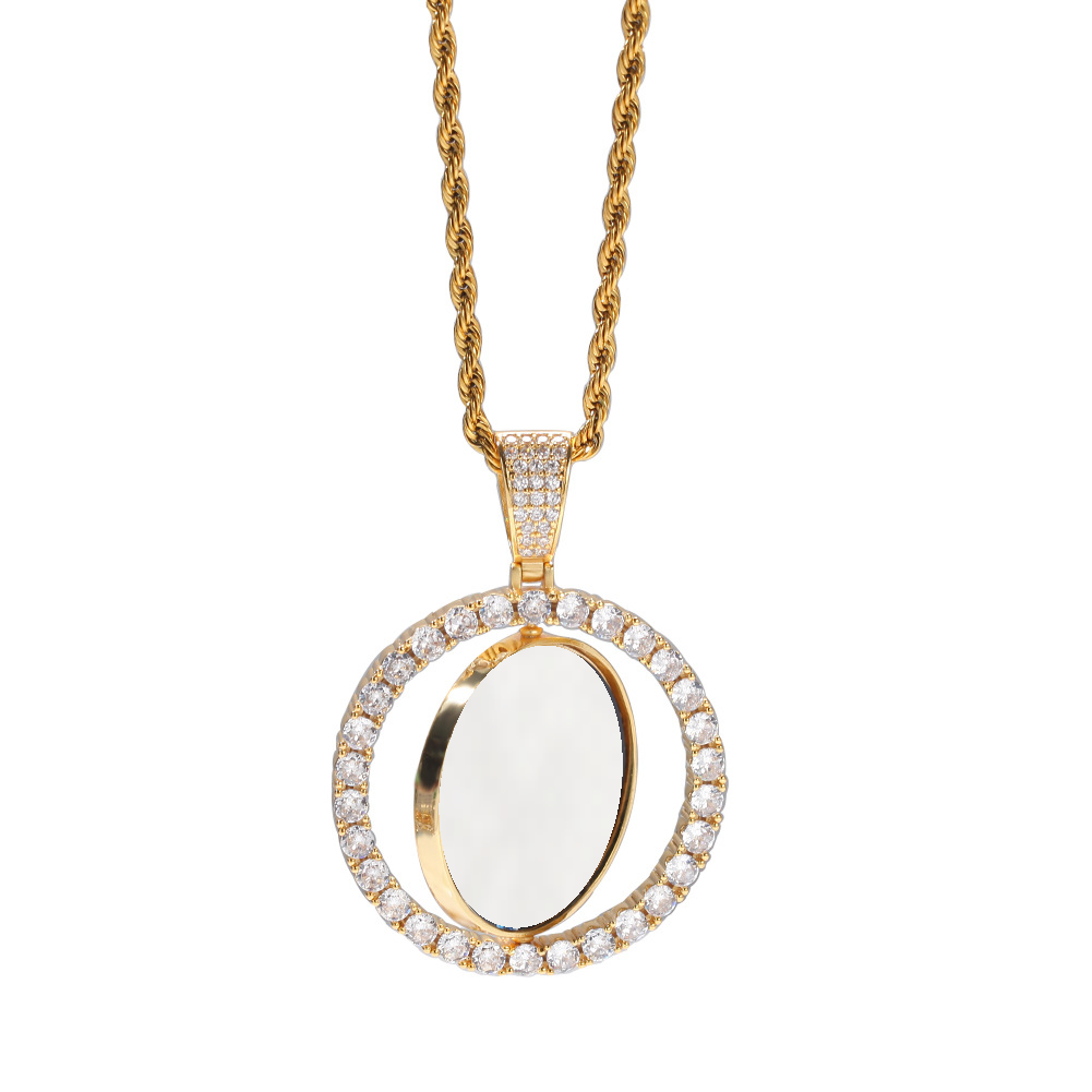 Hanging gold-tone photo pendant showing the white inner disc rotated within the stone-set frame