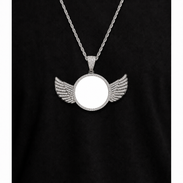 Silver-tone winged photo pendant with a blank white center worn over black