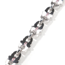 Back of silver-tone floral links showing pink marquise stones and connecting links