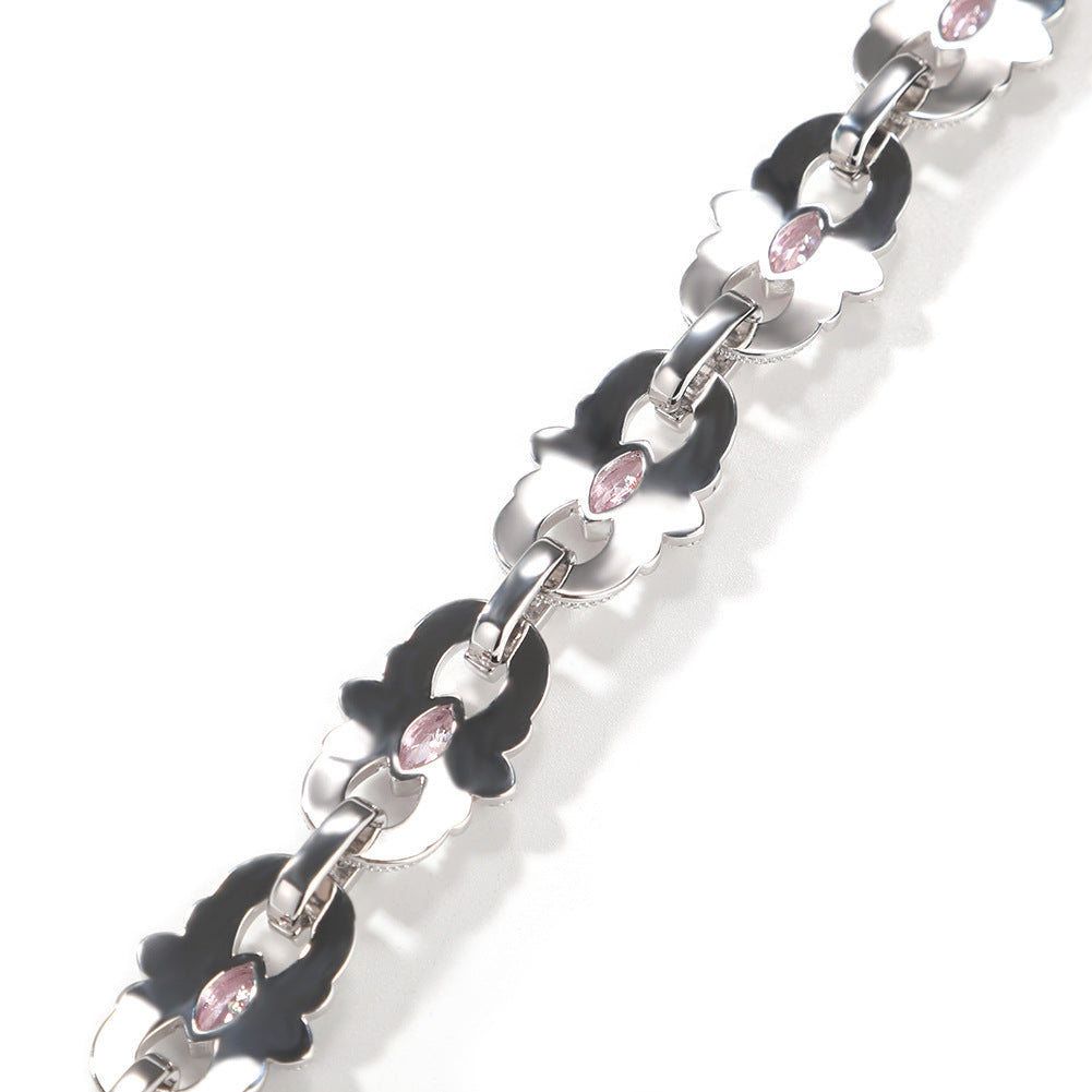 Back of silver-tone floral links showing pink marquise stones and connecting links