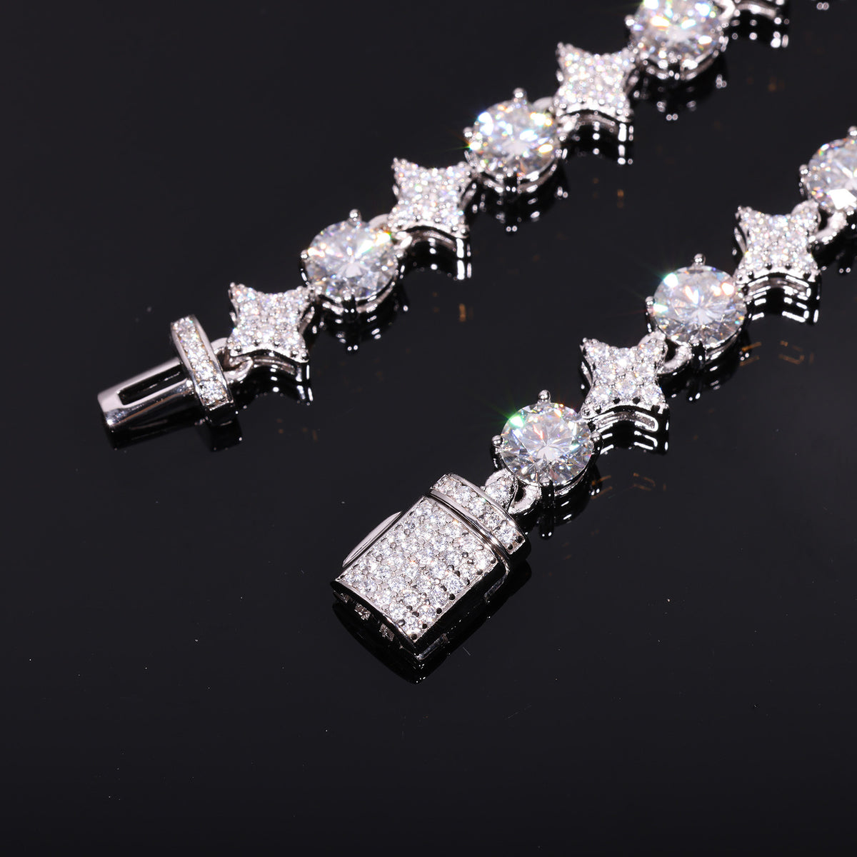 Close-up of silver-tone moissanite star links, round stones and stone-set clasp ends