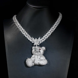Silver-tone bear pendant displayed on a black jewelry bust