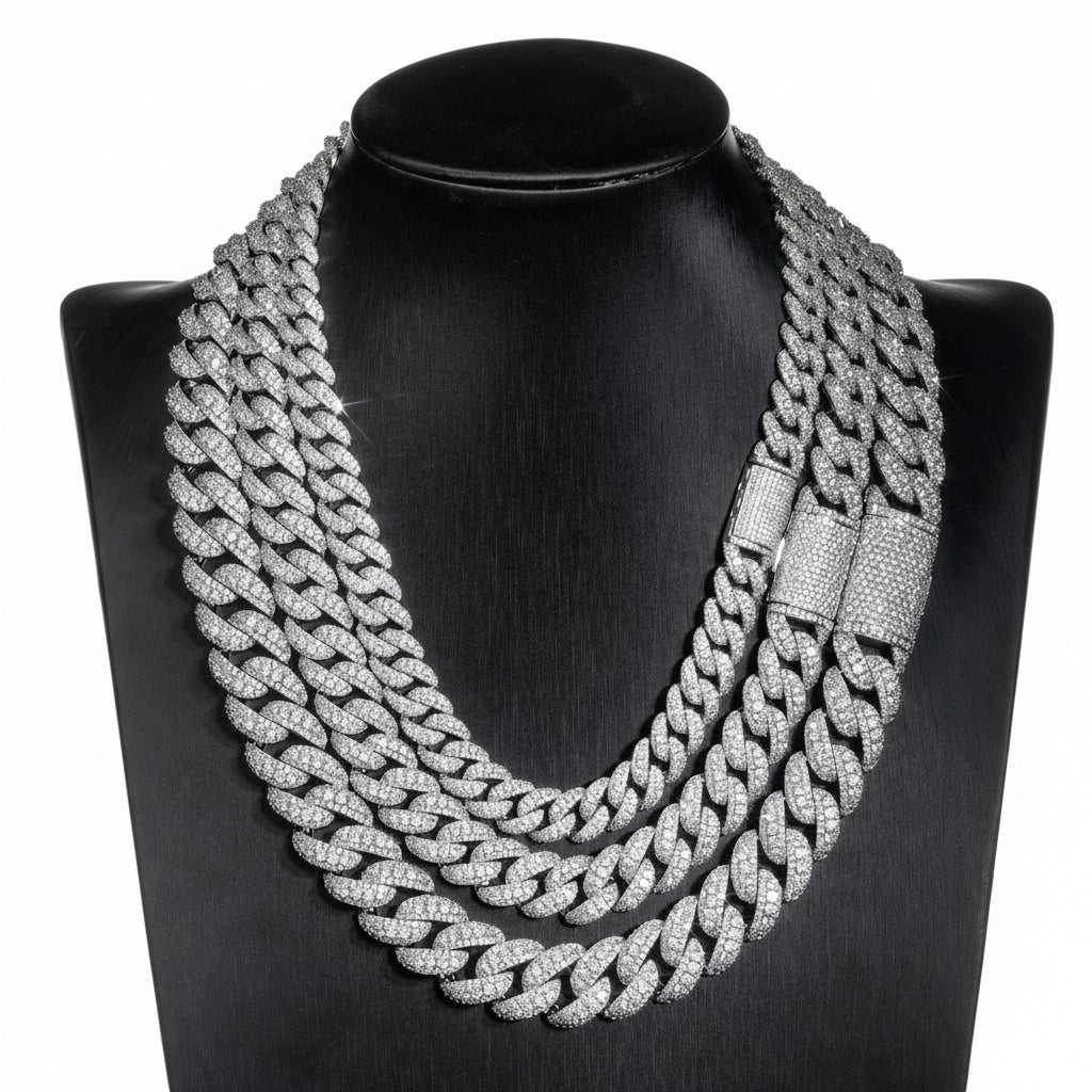 Silver iced Bubble Cuban link chains displayed on a black necklace bust