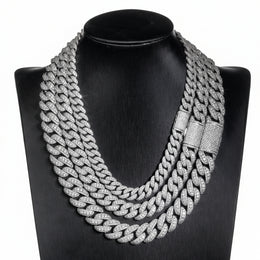 Silver iced Bubble Cuban link chains displayed on a black necklace bust