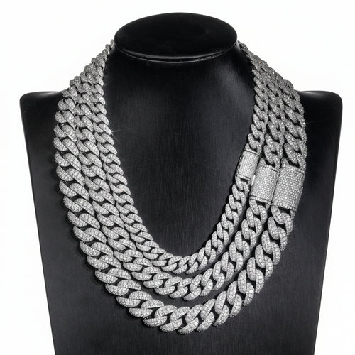 Silver iced Bubble Cuban link chains displayed on a black necklace bust