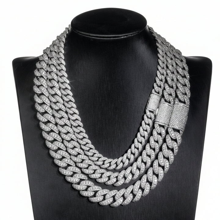 Silver iced Bubble Cuban link chains displayed on a black necklace bust