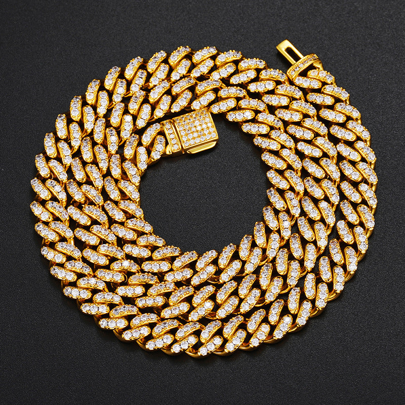 Gold-tone moissanite Cuban chain coiled closely with its clasp visible