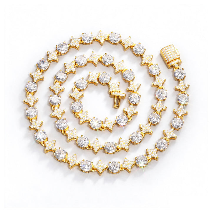 Gold-tone moissanite necklace with alternating star links and round stones, coiled on white
