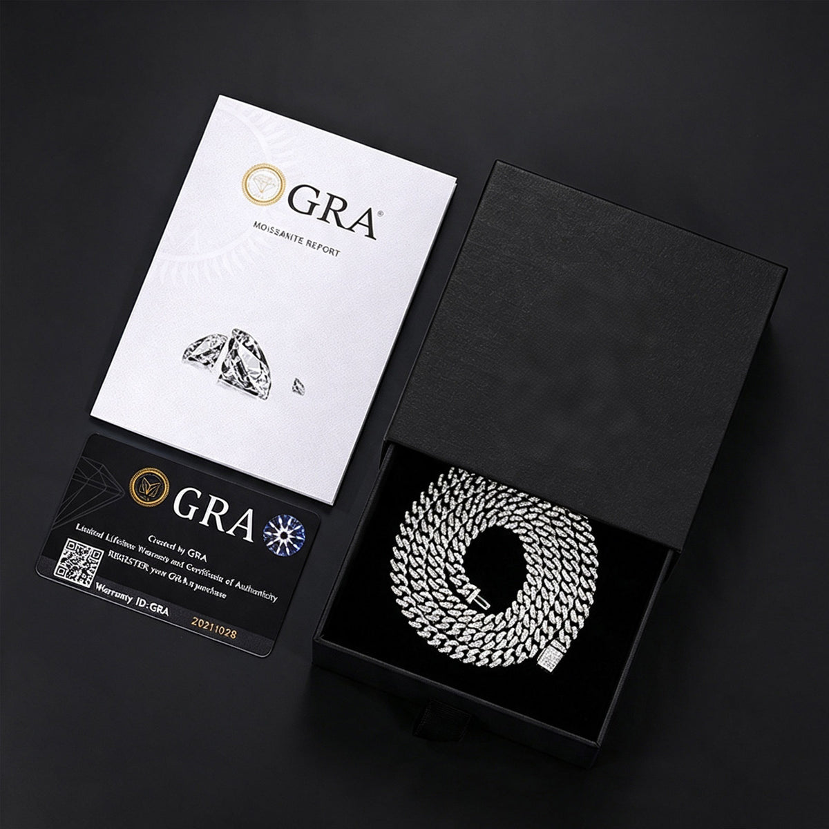 Silver-tone moissanite Cuban chain in a black box beside GRA report papers and a card