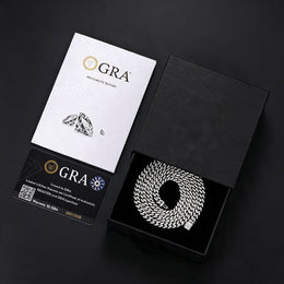 Silver-tone moissanite Cuban chain in a black box beside GRA report papers and a card
