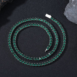 Dark-background detail view of 4mm iced green CZ tennis chain necklace