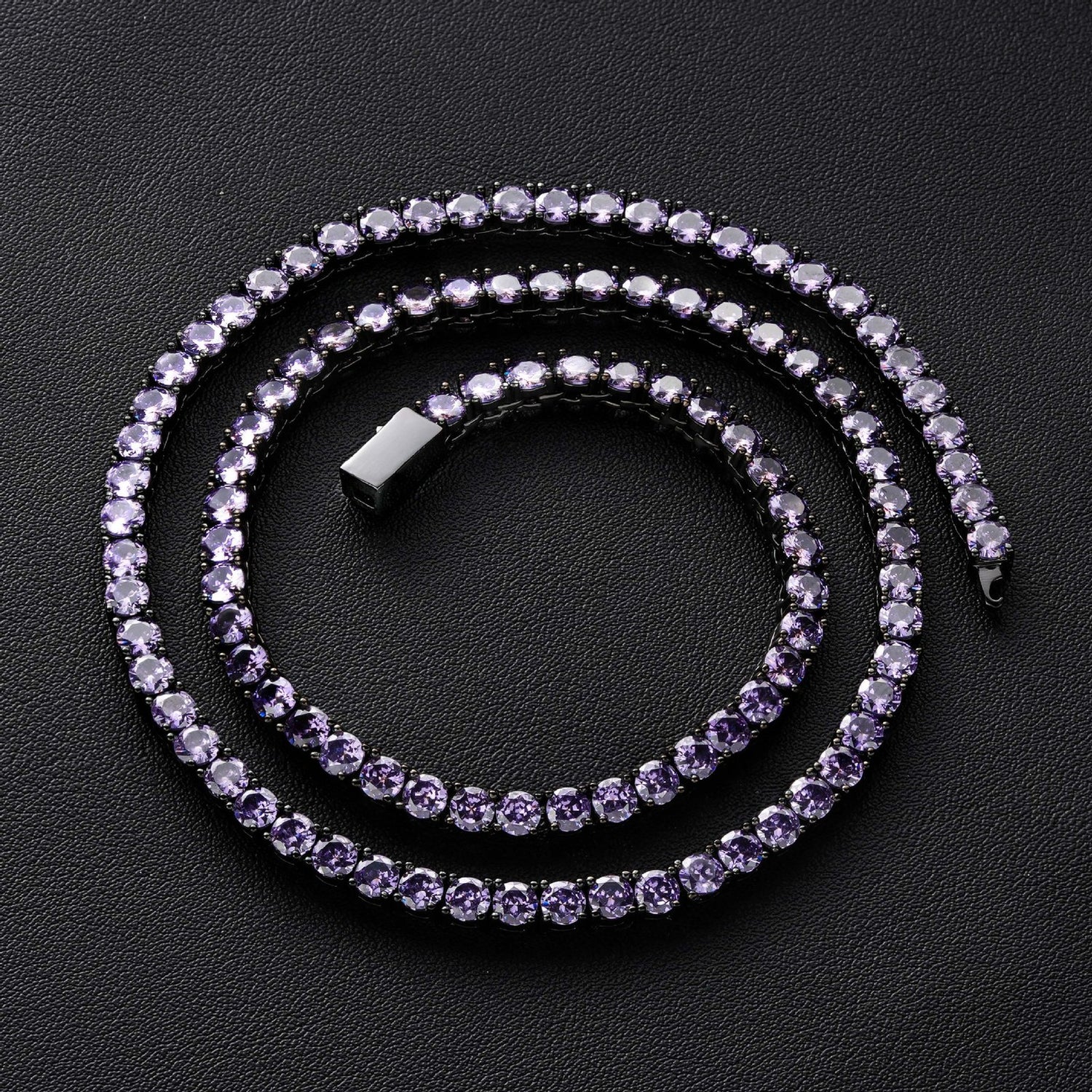 Dark-background detail view of 4mm iced gunmetal purple CZ tennis chain necklace