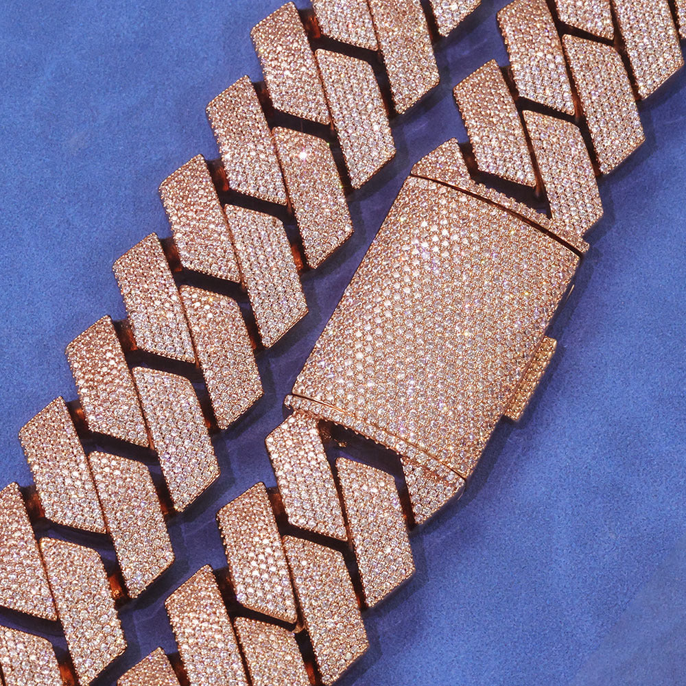 Rose gold-tone pavé box clasp and angular Cuban links on blue fabric