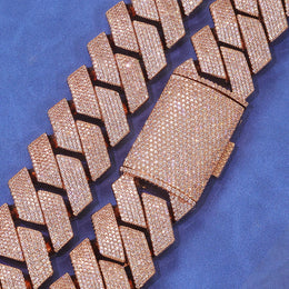 Rose gold-tone pavé box clasp and angular Cuban links on blue fabric