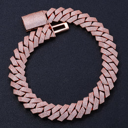 Rose gold-tone iced Cuban links laid in a circle with the box clasp open