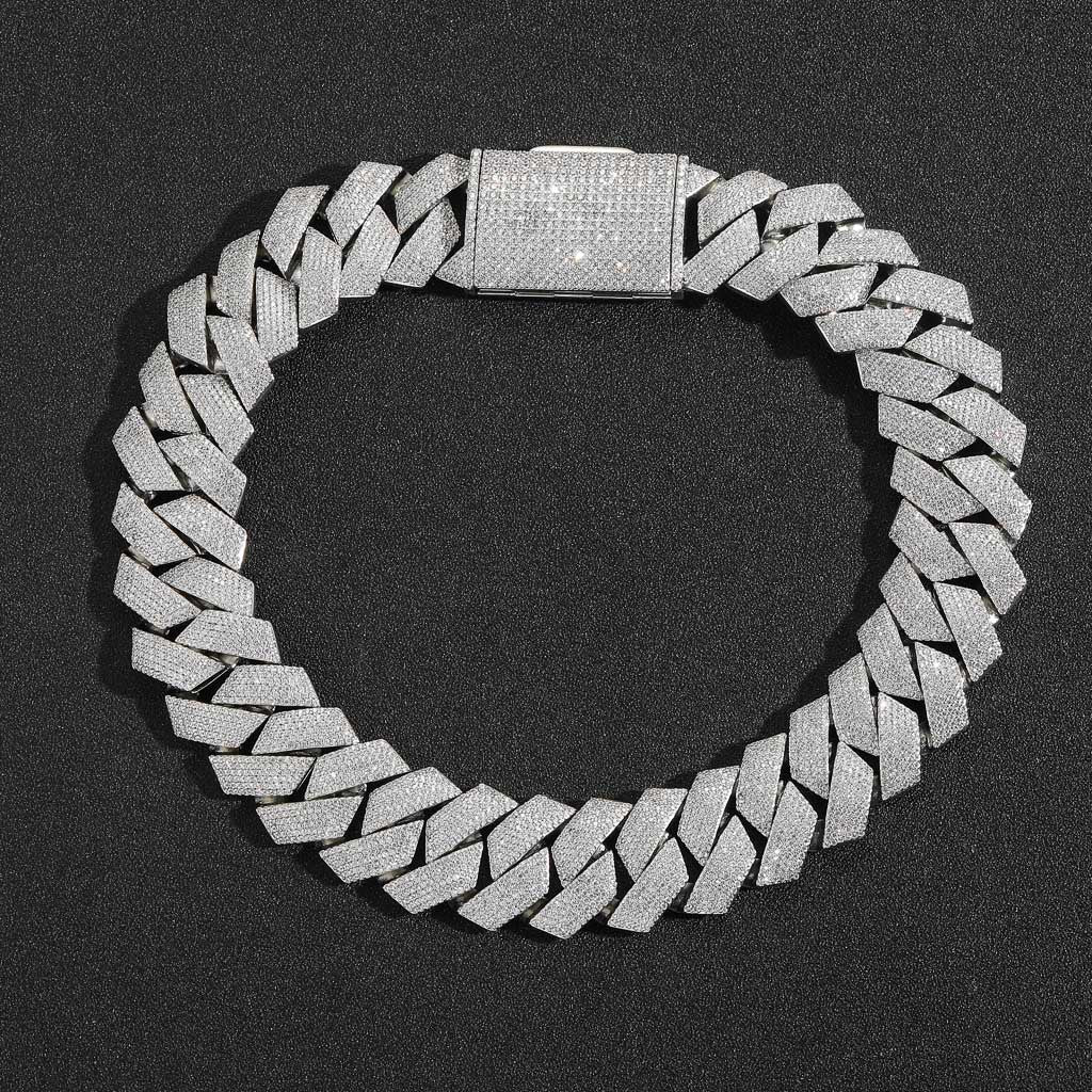 Silver-tone iced Cuban links laid flat in a circle with the pavé clasp visible