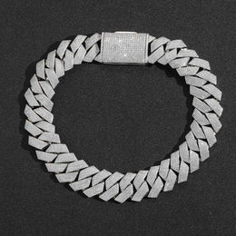 Silver-tone iced Cuban links laid flat in a circle with the pavé clasp visible