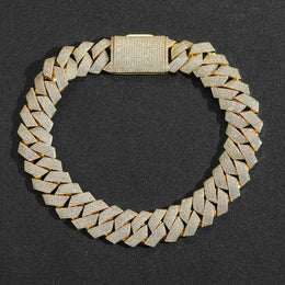 Gold-tone iced Cuban links laid flat in a circle with the pavé clasp visible
