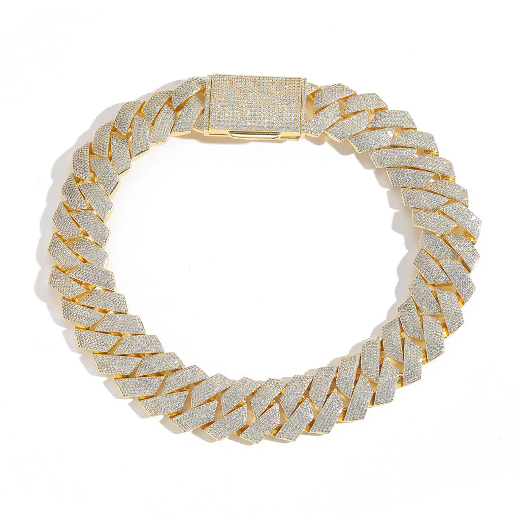 Gold-tone iced Cuban links in a full circular view on white