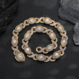 Gold-tone infinity eye-link necklace coiled on a black surface
