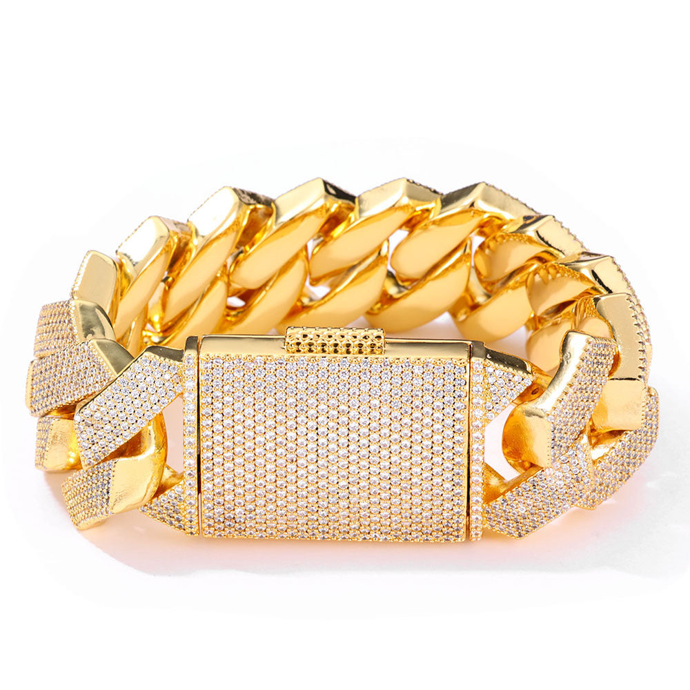 Gold-tone iced Cuban bracelet with a pavé box clasp on white