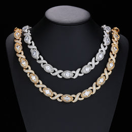 Gold-tone and silver-tone infinity eye-link necklaces on a black display bust