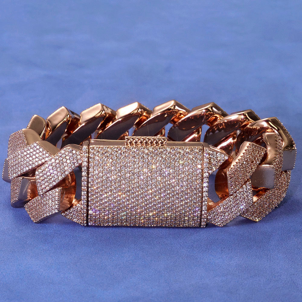 Rose gold-tone iced Cuban bracelet on blue fabric