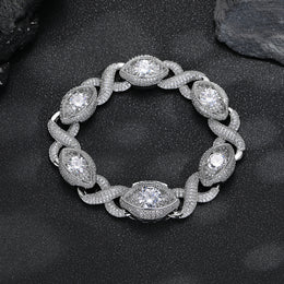 Silver-tone infinity eye-link bracelet on a black surface