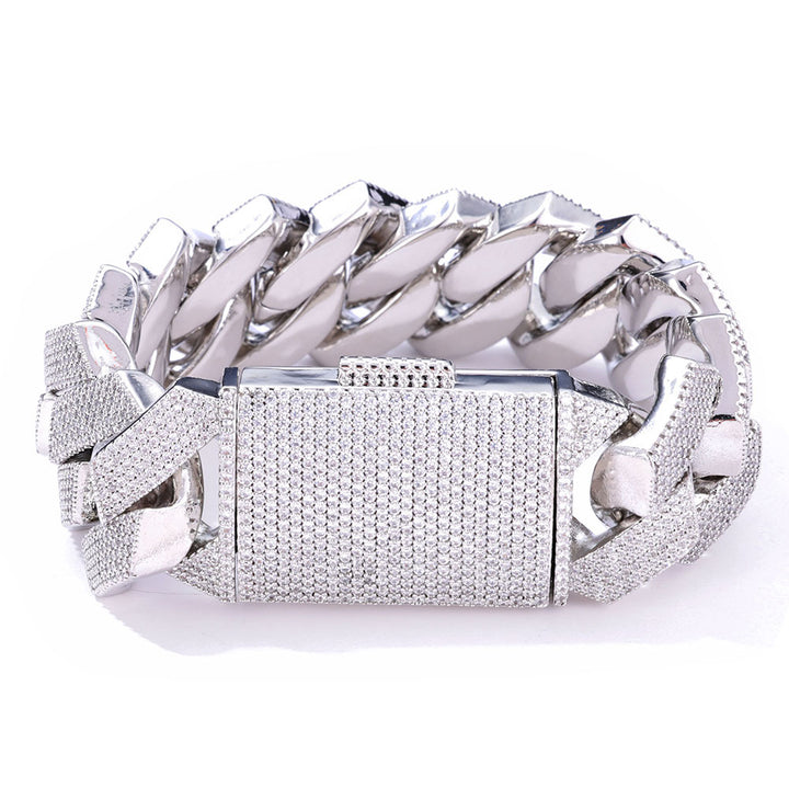 Silver-tone iced Cuban bracelet with a pavé box clasp on white