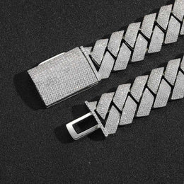 Silver-tone pavé box clasp with its tongue open on black fabric