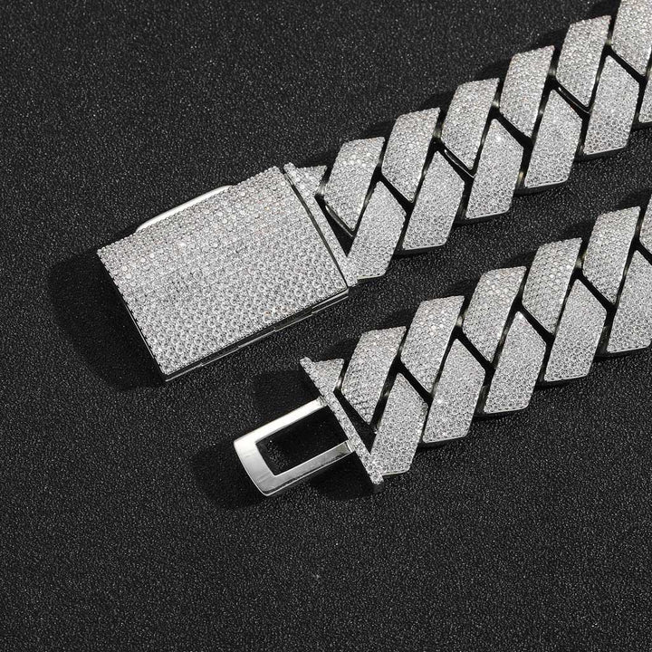 Silver-tone pavé box clasp with its tongue open on black fabric