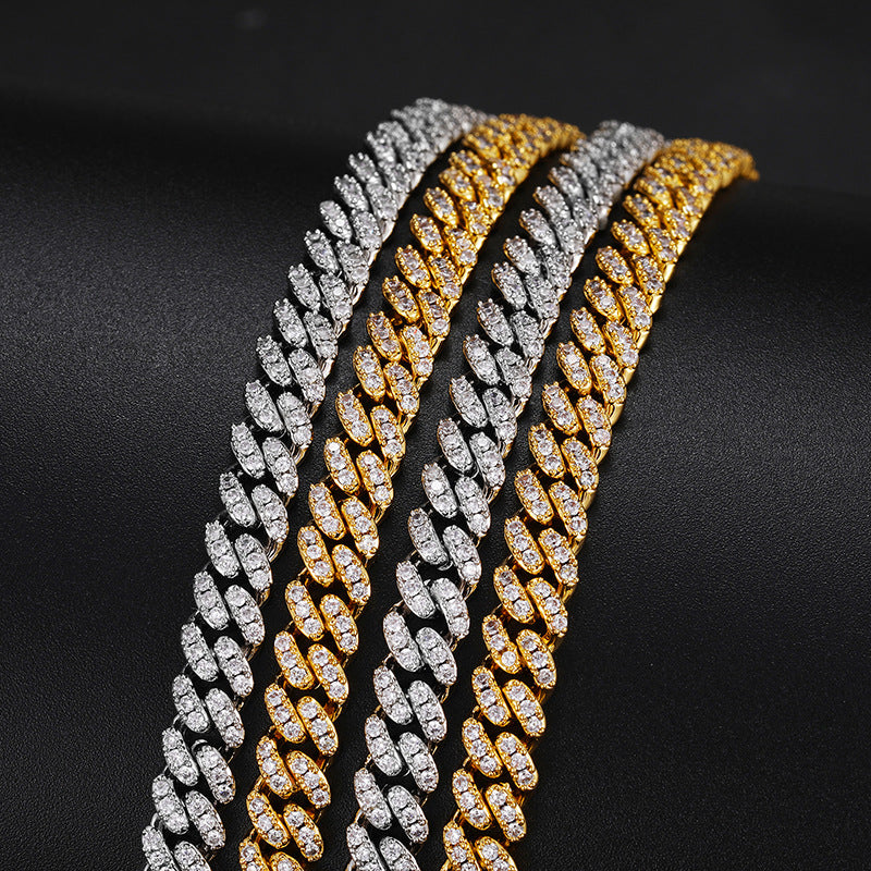 Silver-tone and gold-tone moissanite Cuban links laid side by side on black fabric