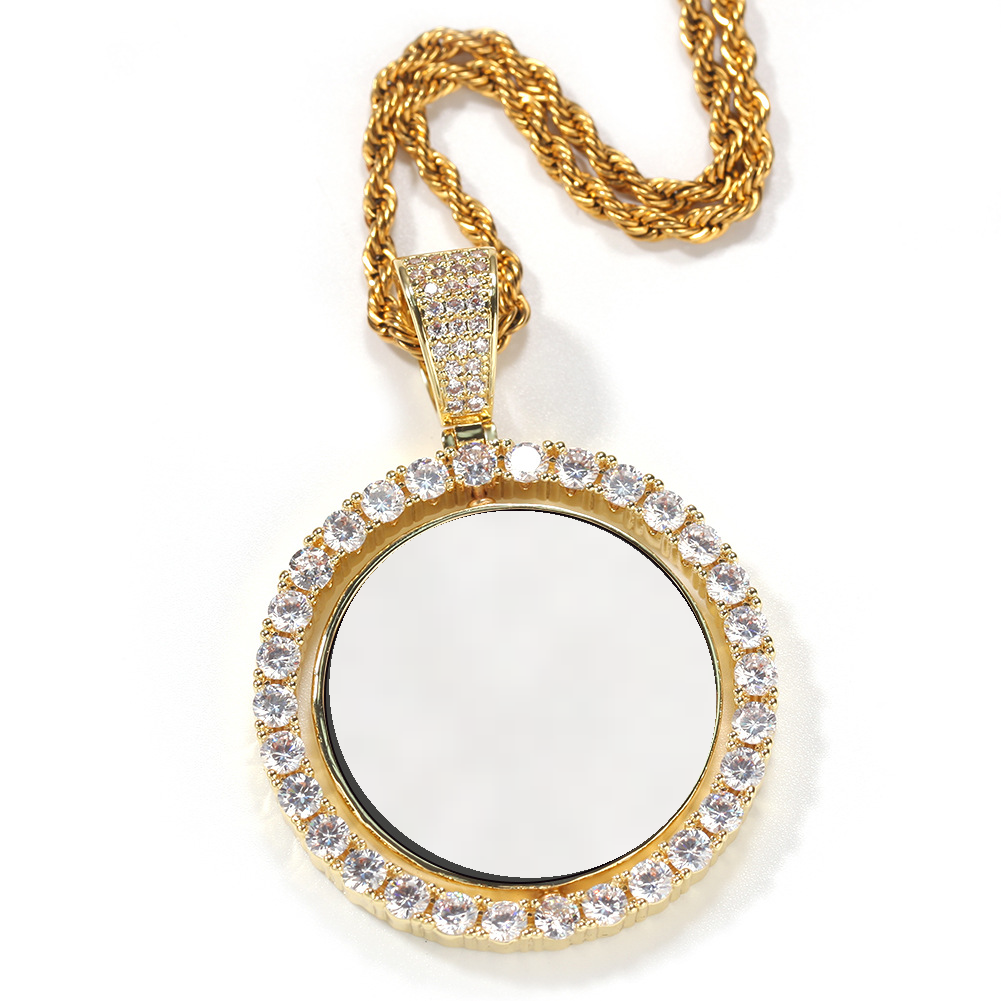 Gold-tone photo pendant with a white photo area and stone-set rim on a white background
