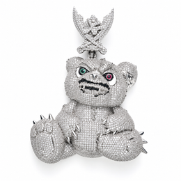 Silver-tone spiked bear pendant with green and red eyes and an ornate bail on white