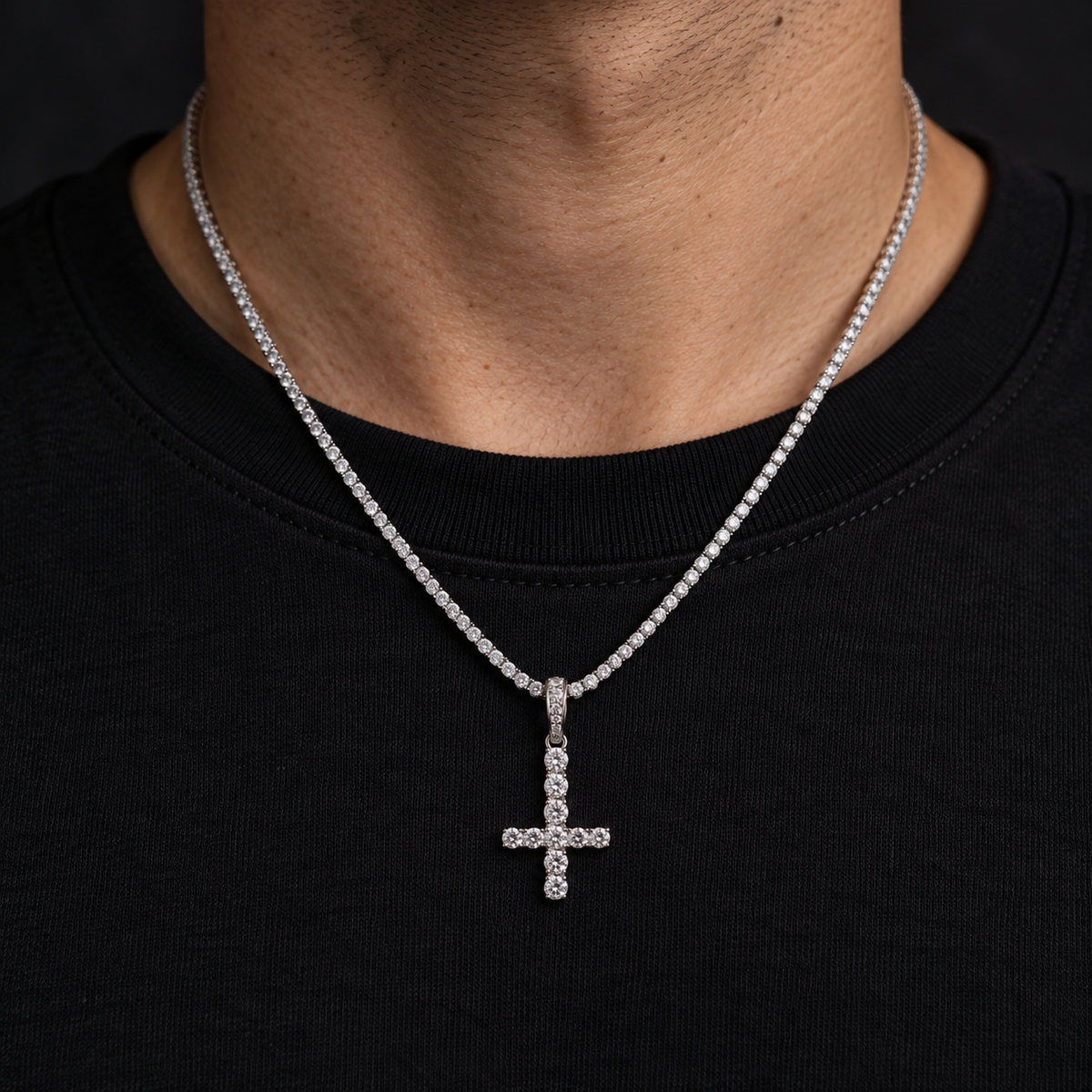 Model wearing a size M silver-tone inverted cross pendant on a tennis chain
