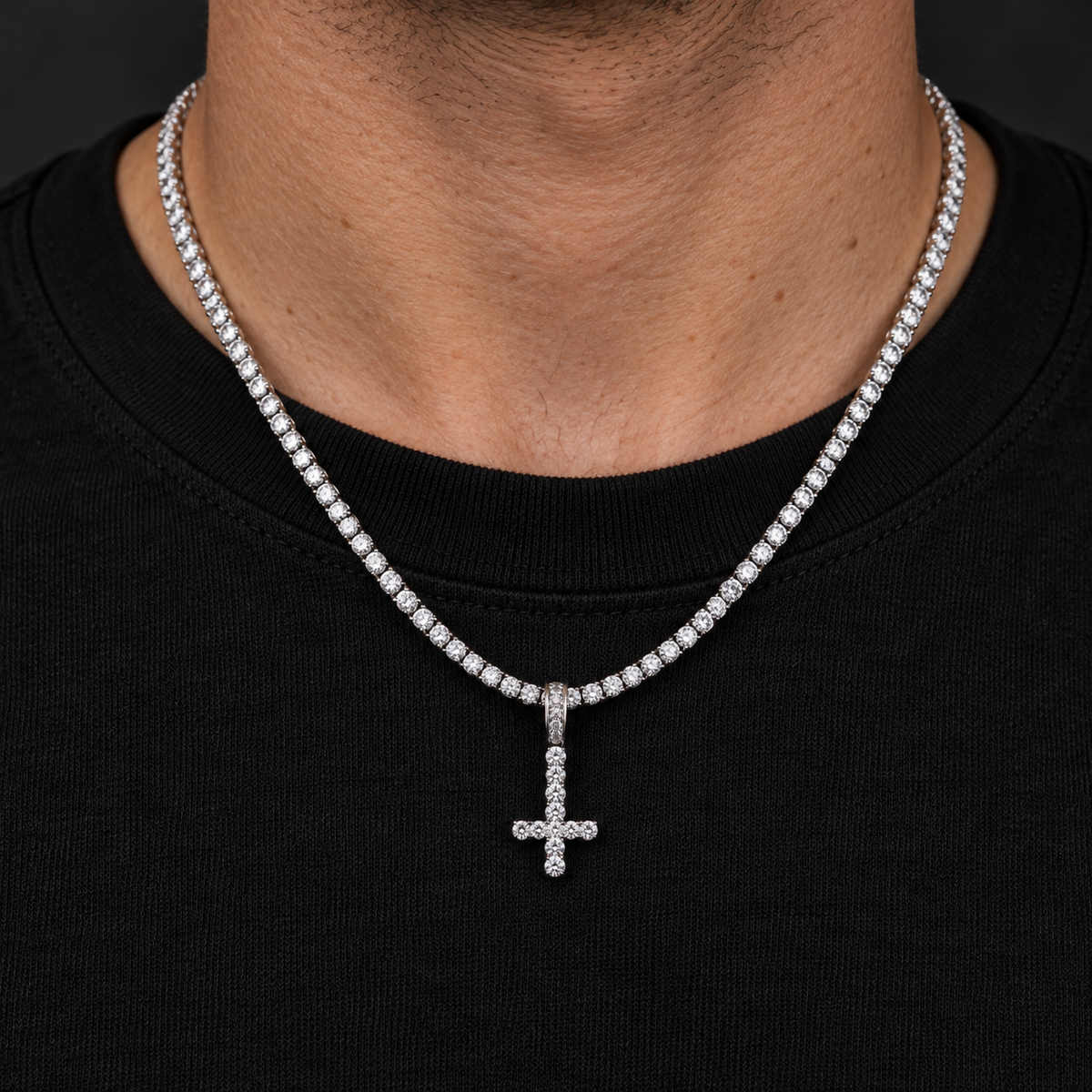 Model wearing a size S silver-tone inverted cross pendant on a tennis chain