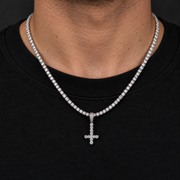 Model wearing a size S silver-tone inverted cross pendant on a tennis chain