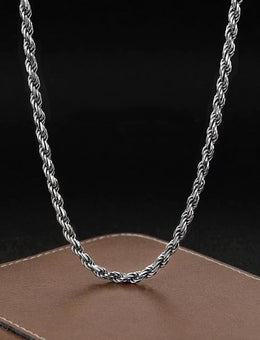 Silver-tone rope chain hanging on a black display bust