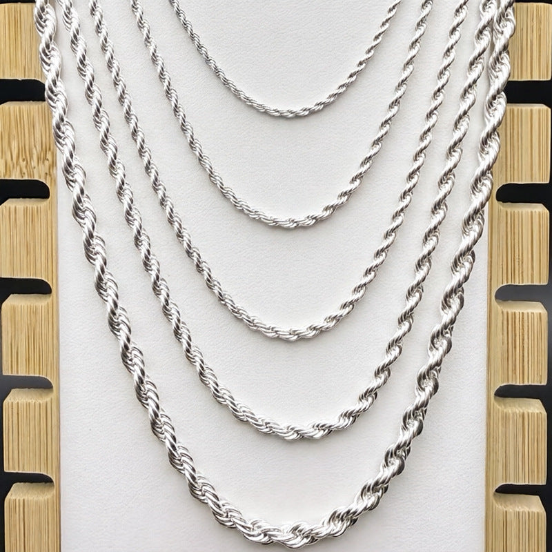 Silver-tone rope chains in graduated widths on a light display bust